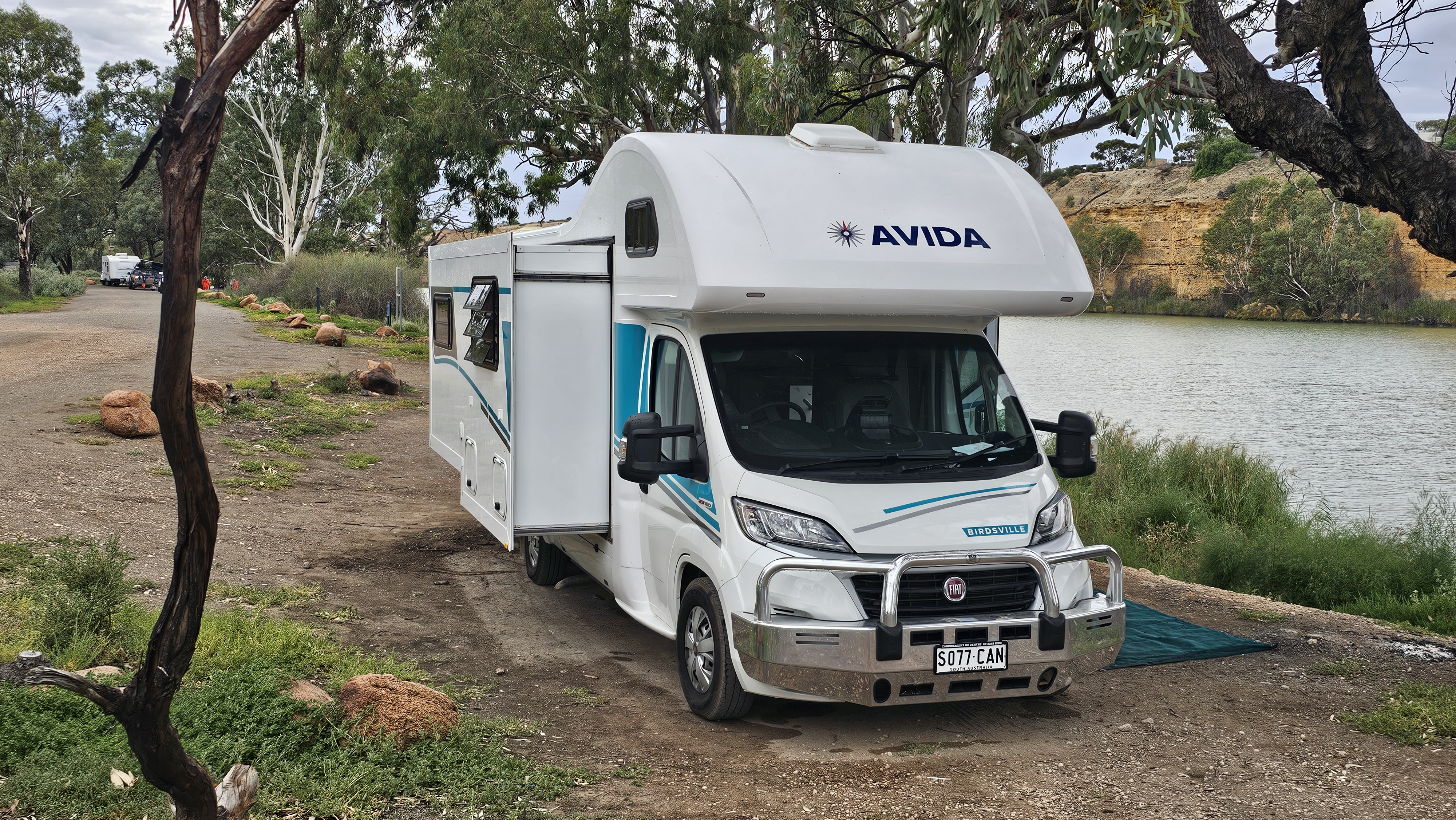 Izzy at a riverside camp